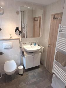 a bathroom with a white toilet and a sink at Haus Sternblick in Bischofswiesen +20 photos