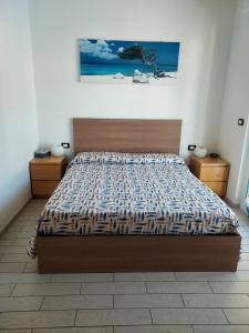 a bedroom with a bed and a painting on the wall at Casa di Doria in Deiva Marina