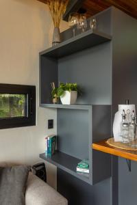 a living room with a shelf and a couch at BiBO Casa Savia in Monteverde Costa Rica +9 photos