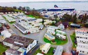 an aerial view of a town with a cruise ship at Cosy Caravan by the sea in Cairnryan