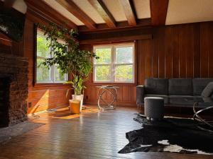a living room with a couch and a fireplace at The 420 House in Kansas City