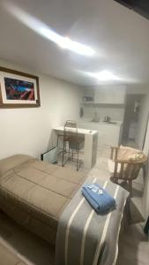 a bedroom with a bed and a table and chairs at Terra Loft in El Chalten