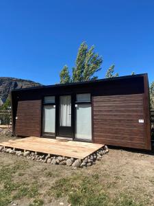 a small house with a wooden exterior at Terra Loft in El Chalten
