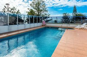 a swimming pool on the roof of a house at Heart of Yeppoon - Ocean View Apartment in Yeppoon
