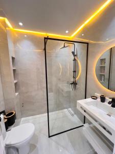 a bathroom with a shower and a toilet and a sink at Dream apartment in Meknès