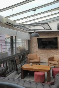 un salon avec un canapé, une table et des chaises dans l'établissement Penthouse en el corazon de RECOLETA, à Buenos Aires