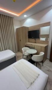 a hotel room with a bed and a table and chairs at فندق ضيافة المدينة in Medina +15 photos