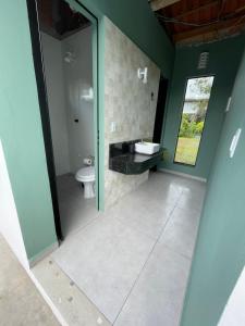 a bathroom with a sink and a toilet at Vila das Toninhas Residence in São Francisco do Sul +7 photos