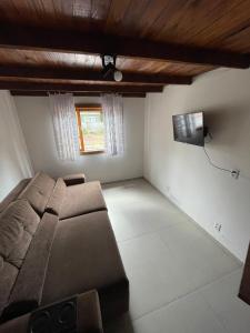 a bedroom with a bed and a television in it at Vila das Toninhas Residence in São Francisco do Sul