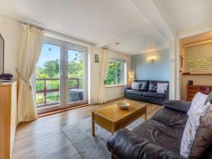 a living room with a couch and a table at The Cottage in Fairlight