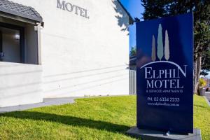a sign for an emirium motel in front of a building at Elphin Serviced Apartments in Launceston
