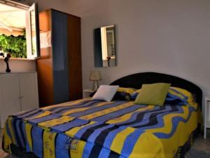 a bedroom with a bed with a laptop on it at Studio Apartment in Supetar