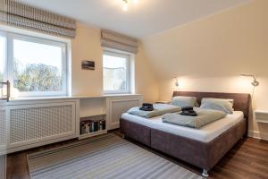 a large bedroom with two beds and a window at Ferienhaus in St Peter-Ording in Ording
