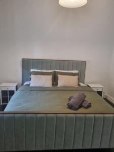 a large bed with two pillows on top of it at Little Yellow Guesthouse in Melbourne