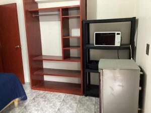 a kitchen with a refrigerator and a microwave at Habitación privada zona Satélite in Mexico City +7 photos