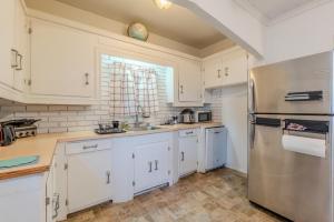 a kitchen with white cabinets and a stainless steel refrigerator at Cozy 4BDR, Tufts, Train, Parking, 10 min to Boston in Medford +15 photos