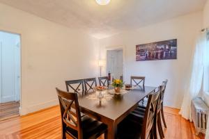 a dining room with a table and chairs at 4BDR|Tufts|Train|Free Parking in Winter Hill