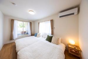 Ένα ή περισσότερα κρεβάτια σε δωμάτιο στο AMP FLAT Baika