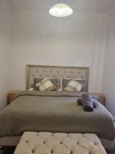 a bedroom with a large bed with pillows at Little Yellow Guesthouse in Melbourne
