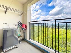a room with a balcony with a view of a field at Lumiere Apartment Swanbay in Nhơn Trạch
