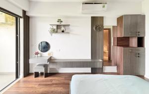 a bedroom with a bed and a desk in a room at Lumiere Apartment Swanbay in Nhơn Trạch