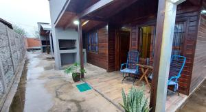 a patio of a house with chairs and a table at JuanSe Cabaña in Ituzaingó