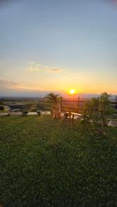 een zonsondergang in een veld met een bank in het gras bij LA TRAGONA - Casa Campestre in El Cerrito +23 foto's