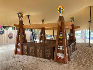 a wooden play structure in a tent at Tropical eglamping Mũi Né in Ấp Long Sơn