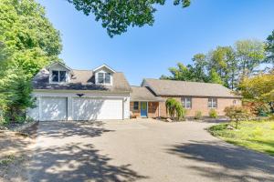 a brick house with a garage and a driveway at Live Large on Saddle Lake! Family Home with Dock in Grand Junction