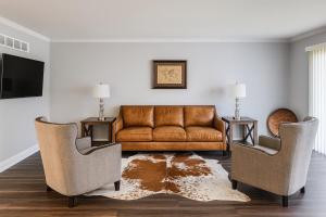 a living room with a couch and two chairs at Suburban Retreat 15 Mins to Downtown Detroit in Southfield