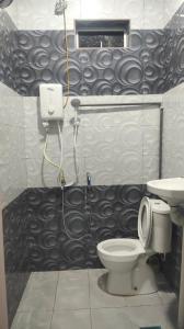 a bathroom with a shower and a toilet and a sink at Riverview Homestay Sekoh Kuala Krau in Kuala Kerau