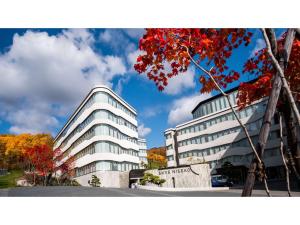 an office building with a tree in front of it at Skye Niseko - Vacation STAY 30783v in Niseko