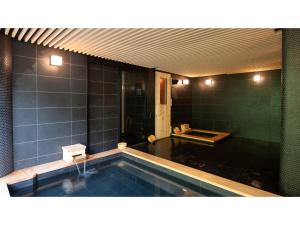 a bathroom with a swimming pool in a room at Skye Niseko - Vacation STAY 41529v in Niseko