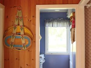 a small room with a window and a curtain at 4 person holiday home in Skummeslövsstrand in Skummeslövsstrand