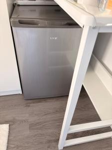 a dishwasher sitting next to a white desk at Modern En-Suite Double Bedroom in Cardiff with Private Entrance in Cardiff