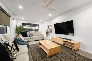 a living room with a large flat screen tv at 2 Luton in Yarrawonga