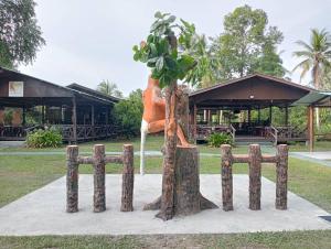 a statue of a tree in a park at Borneo Kelip Kelip Lodge Beaufort in Beaufort