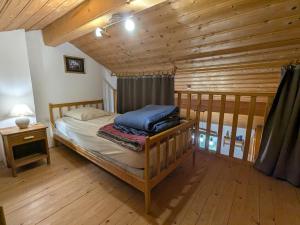 a bedroom with a bed and a wooden ceiling at Chalet confortable dans les Vosges - 2 gîtes indépendants - FR-1-589-838 in Le Ménil