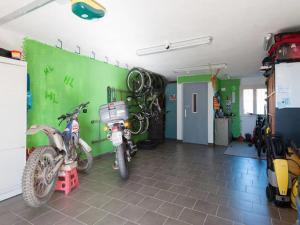 a garage with two motorcycles parked in a room at Tolasudolsa Rooms, Breakfast & Mountain Bike in Compiano