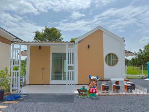 a toy house with a doll standing in front of it at RT House Resort in Ban Phawon