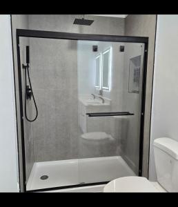a bathroom with a shower with a toilet and a sink at Vacation Home in Bradenton +5 photos