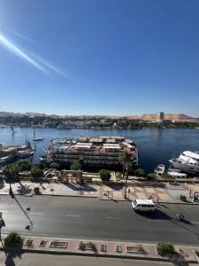a view of a marina with boats in the water at NubaNest GuestHouse in Aswan +43 photos