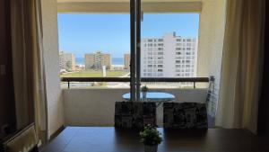a balcony with a table and a view of a city at Nova Pacifico in La Serena