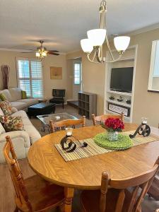 a living room with a wooden table and a living room with a couch at Mins to Blessing Hospital, Miss River, Country Club in Quincy