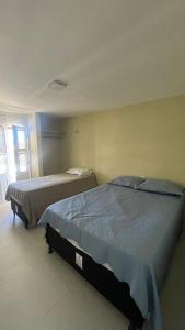 a bedroom with two beds in a room at Casa Beach park in Aquiraz +14 photos