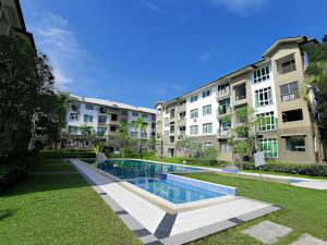 a swimming pool in front of some apartment buildings at Natol Homestay - Kuching Home Penthouse Airport Road in Kuching