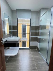 a bathroom with a sink and a shower at NovaWonderland Ho Tram Villa in Xuyên Mộc