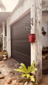 a garage door with a plant in front of it at Peradeniya Inn in Kandy