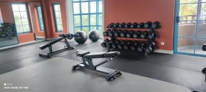 a gym with dumbbells and weights in a room at NovaWonderland Ho Tram Villa in Xuyên Mộc