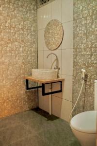 a bathroom with a sink and a toilet at Desa Huis Yogyakarta in Gandok